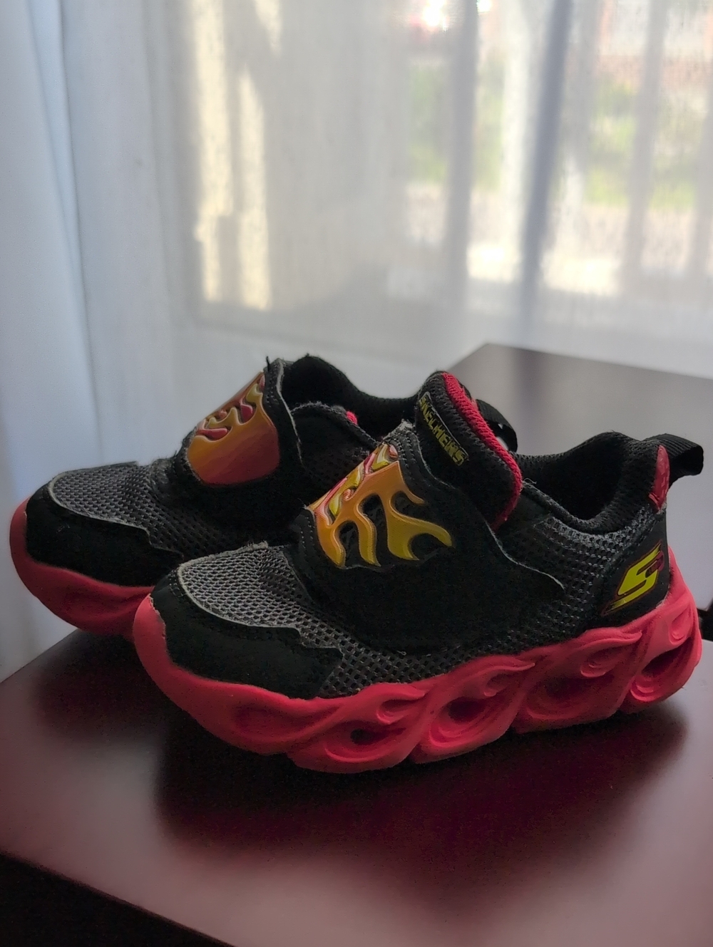 Skechers Kids Black Sneakers with Red Soles and Yellow Flame Detail